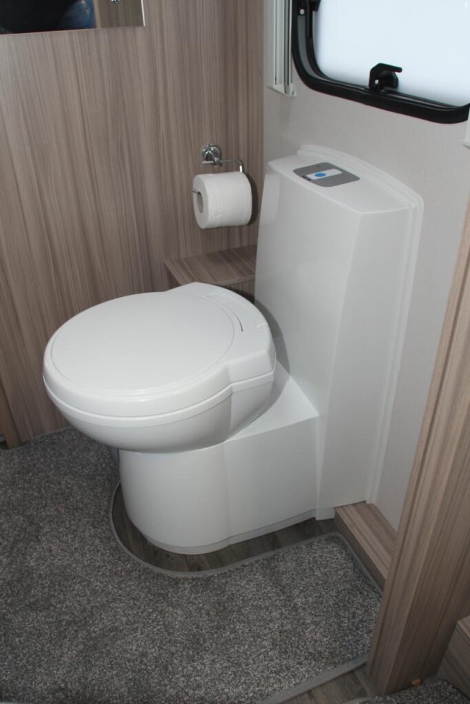 A caravan toilet with electric flush and swivelling seat